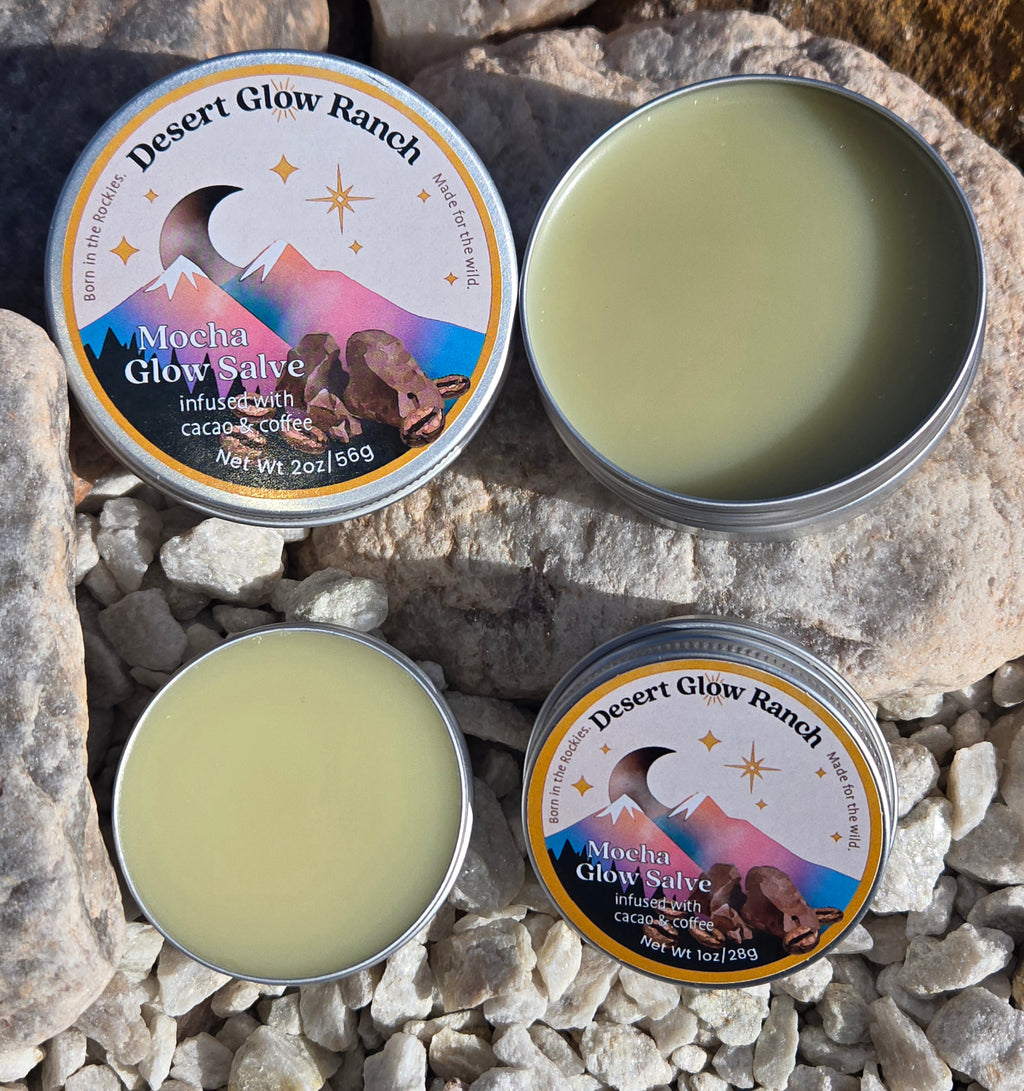 Mocha glow salve organic coffee and chocolate moisturizer in 1 oz and 2 oz tins on natural rock surface